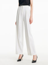 a woman in white culottes pants